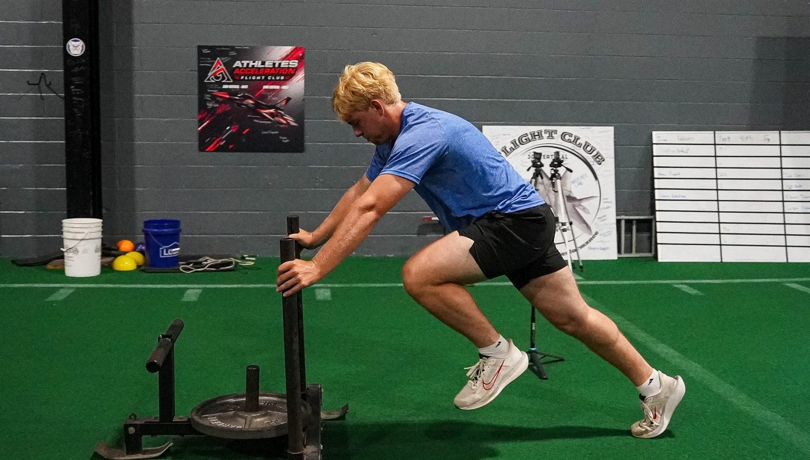Athlete pushing a weighted sled